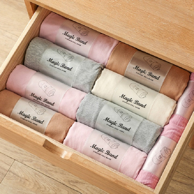 Drawer organizer filled with assorted colored roll straps for bundling clothing