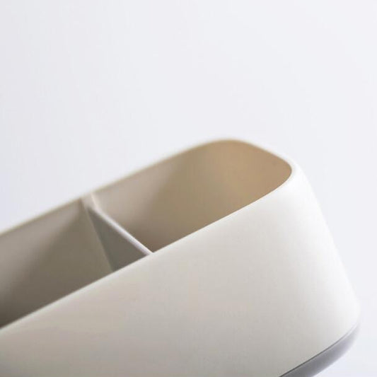 White sock storage box with beige interior compartments and curved open top.