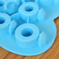 Blue silicone ice mold close-up showing a ring-shaped cavity