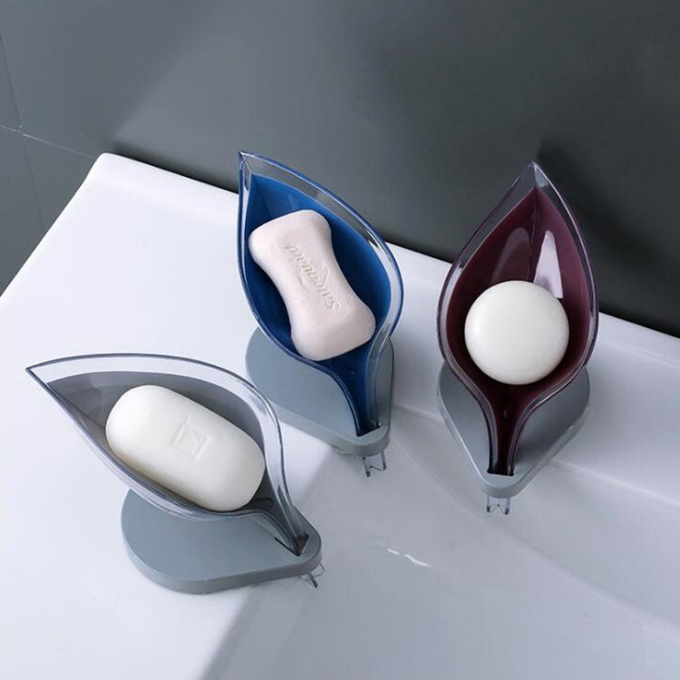 Transparent leaf-shaped suction soap holders with soap bars, blue and dark red