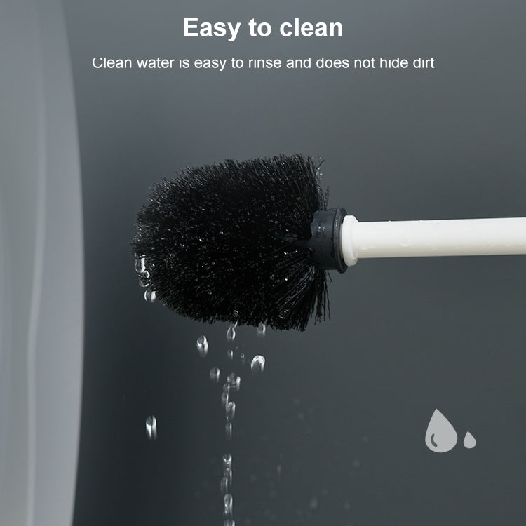 Wall-mounted toilet brush head with dense black bristles, water droplets nearby