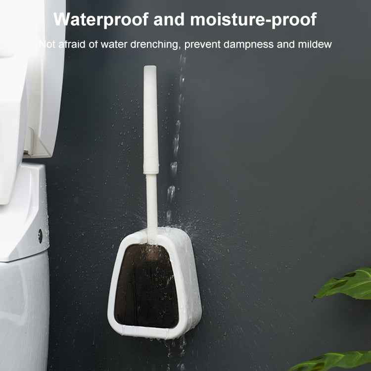 Wall-mounted toilet brush and base positioned against a surface, bristles upright