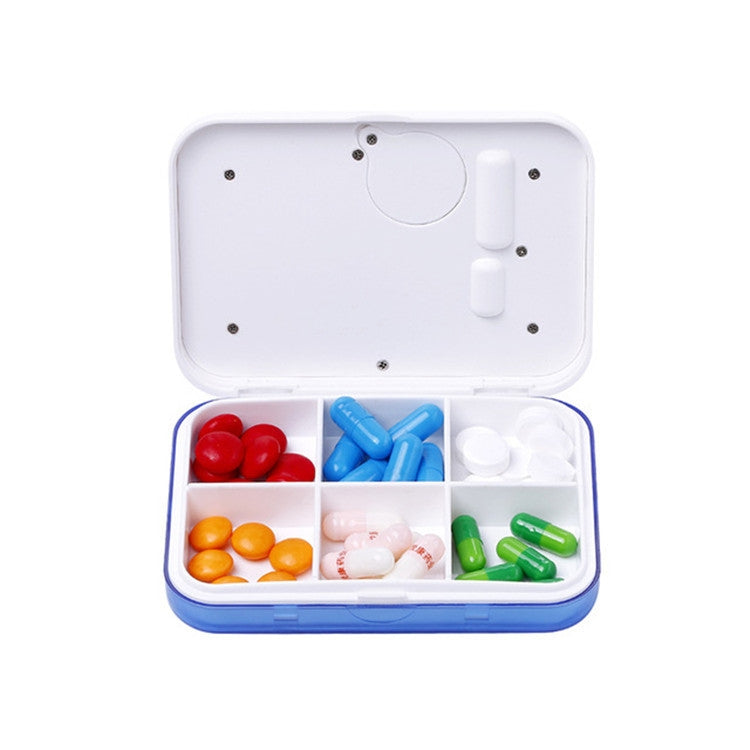 Mini electronic 6-compartment pill box, open lid showing red, blue, orange, green capsules