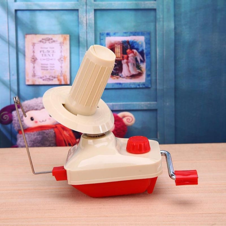 Handheld yarn winding machine with beige spool guide, red crank handle, and metal rod