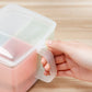 Hand holding a lid on a three-compartment pastel kitchen container with spoon