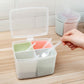 Three-compartment spice box with open lid, pastel inserts, and small spoon