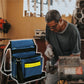 Blue electrician tool belt bag worn on a belt, with front pockets and accessory clips.