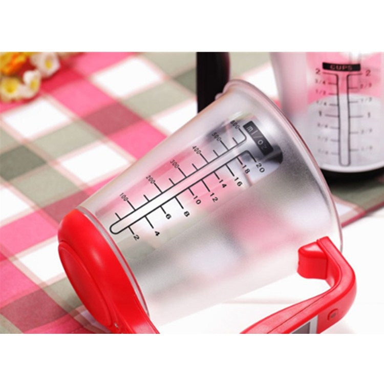 Close-up of measurement markings on a red electronic measuring cup scale