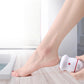 USB foot grinder held against a person’s foot for at-home pedicure