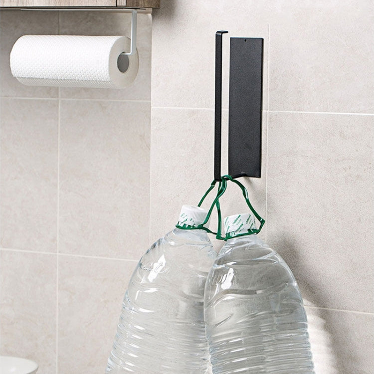 Wall-mounted roll holder towel rack in matte black on tiled wall