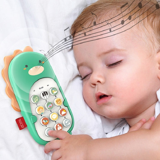 Green dinosaur toy smartphone held by a baby on a soft blanket