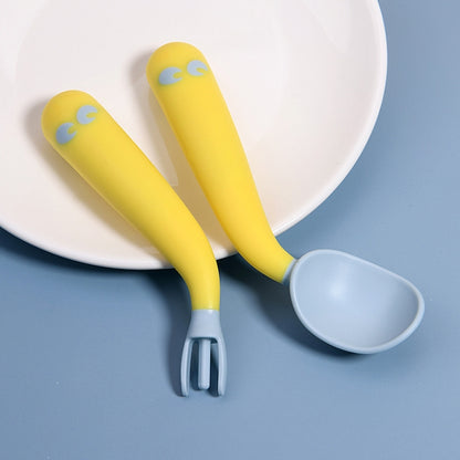 Baby learning yellow spoon and fork set with curved tips