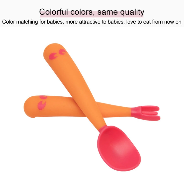 Baby learning orange spoon and fork set with pink utensil ends