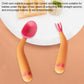 Baby learning curved pink spoons and fork tips with orange handles