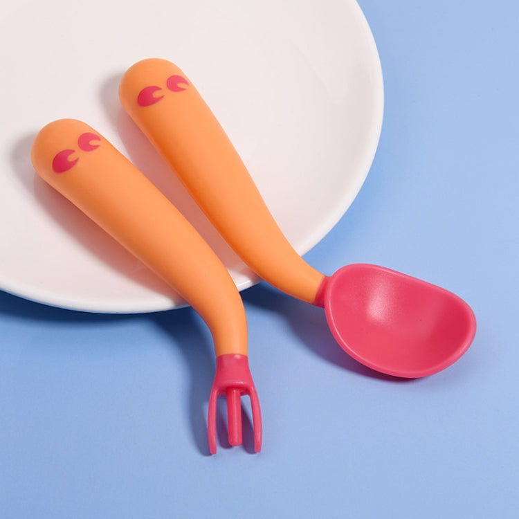 Baby learning-to-eat spoon and fork set with orange handles and pink scoop
