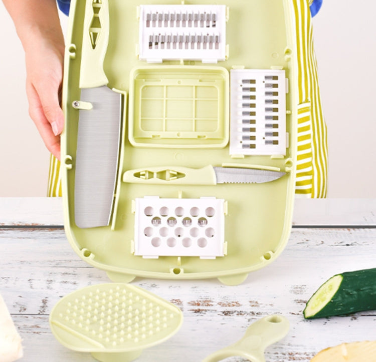 Folding plastic cutting board open with grater and slicing attachments, light green set