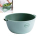 Light green round plastic vegetable drain basket with side carry handles