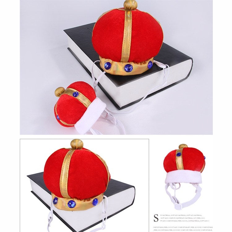 Red plush pet crown hat with gold band, blue gem decorations, and white elastic straps shown on stand.