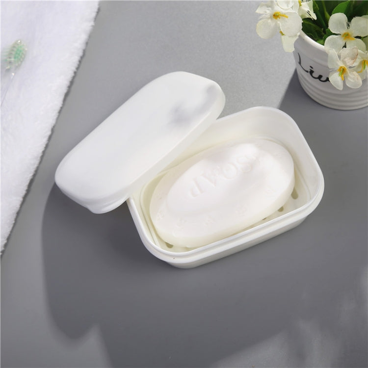 White plastic soap holder with lid open and soap inside