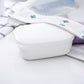 White plastic soap holder with snap lid resting on folded cloth
