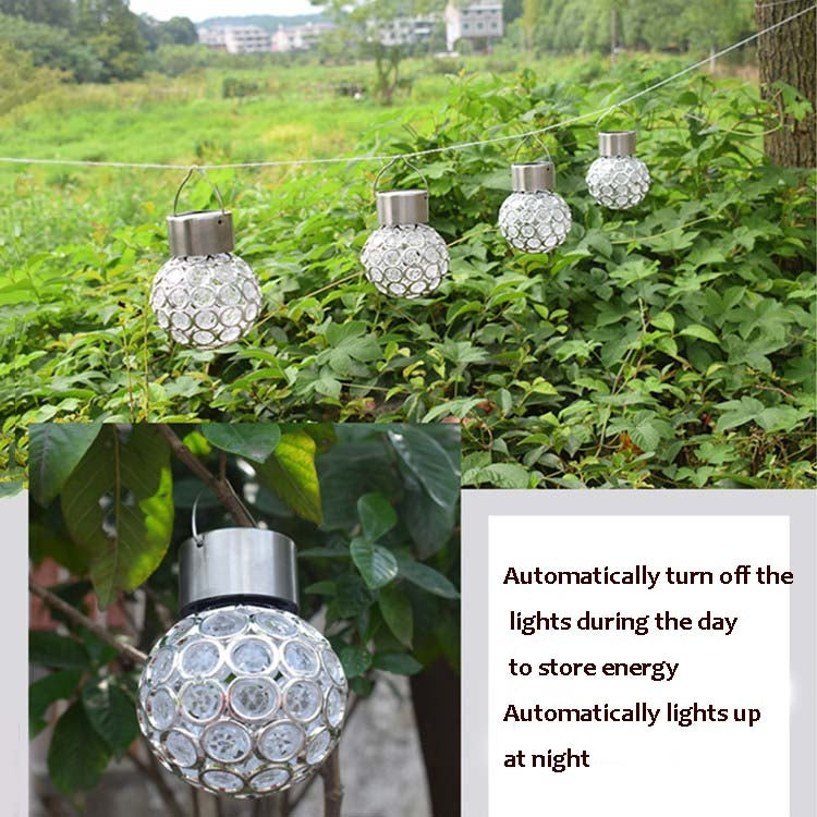 Multiple solar hollow ball pendant lights with white glowing faceted globes