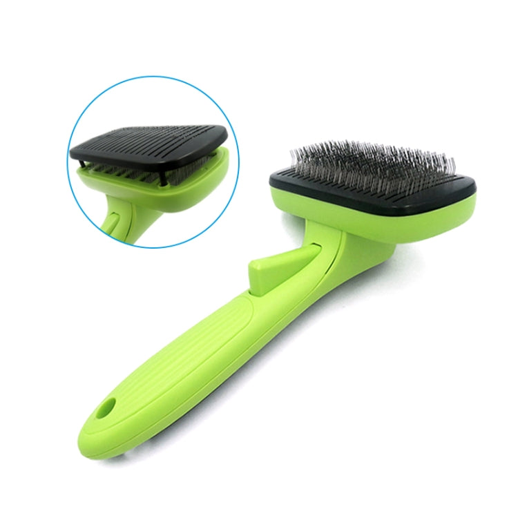 Green grooming comb with black bristles and protective rubber pad head