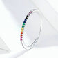 Silver rainbow zircon band ring with colored stones along the outer edge