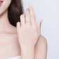 Hand wearing a slim silver band ring with multicolor zircon stones