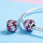 Pair of round purple gemstone bead charms on silver snake bracelet