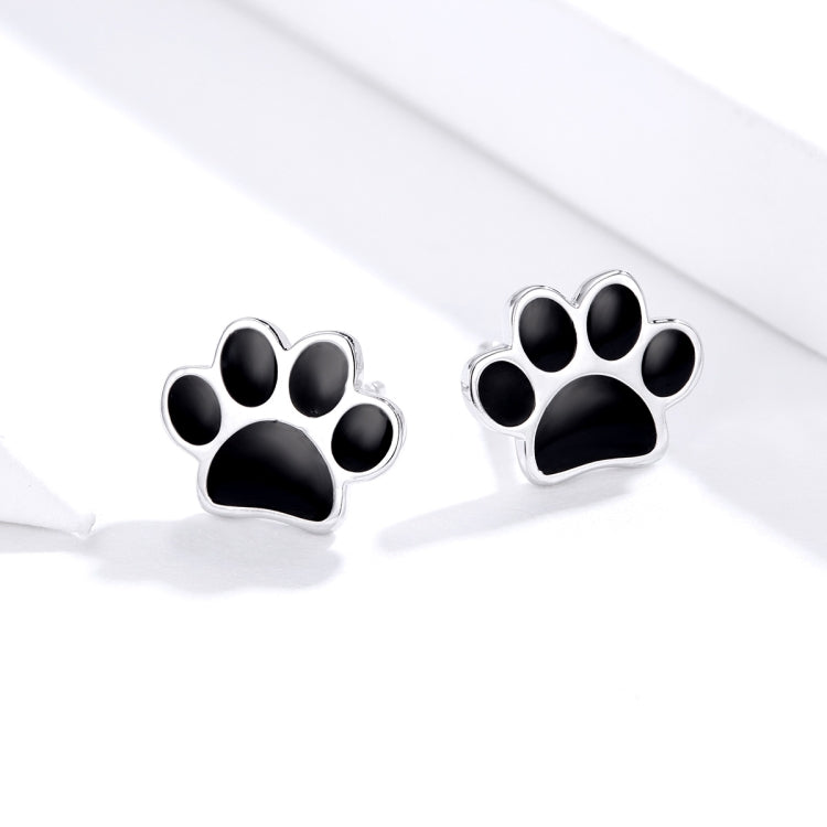Sterling silver paw print stud earrings with black enamel paw pad design on each side