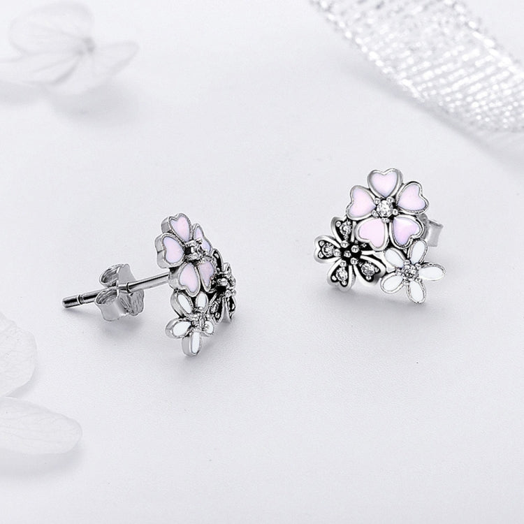 Sterling silver flower stud earrings with pink enamel petals, CZ details, and stud back