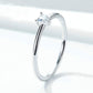 Heart-shaped clear CZ solitaire ring on polished silver band, side view