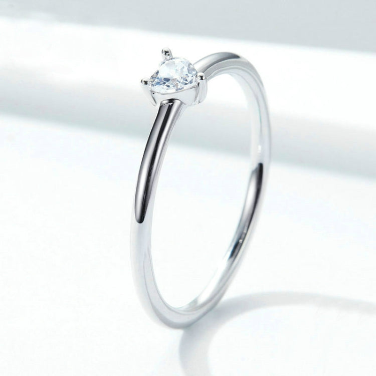 Heart-shaped clear CZ solitaire ring on polished silver band, side view