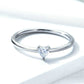 Heart-shaped clear CZ solitaire ring with slim silver band, top view