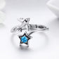 Silver open ring with stacked star charms and blue CZ center stone