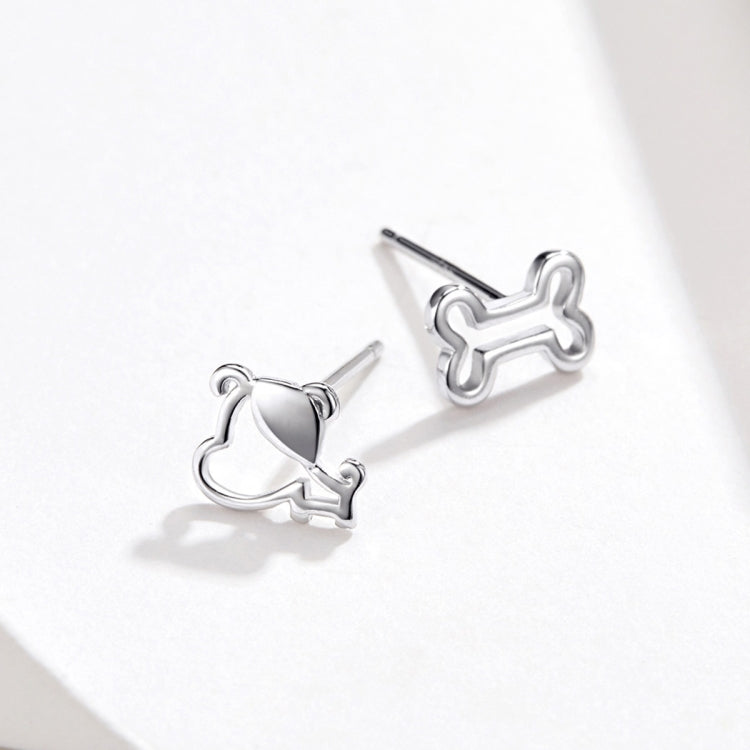 Sterling silver dog bone stud earrings with hollow outline, angled profile