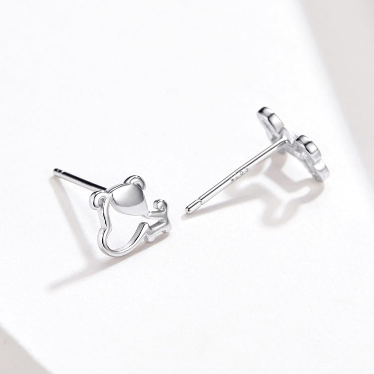 Sterling silver dog bone stud earrings with posts shown, angled view