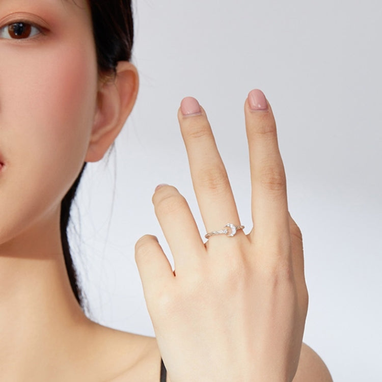 Sterling silver open star and moon ring with zircon accents on hand