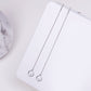 Sterling silver drop earrings, two thin chains with round crystal charms.