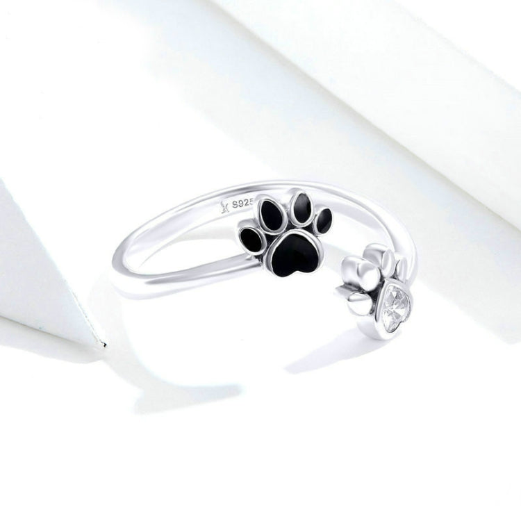 Sterling silver paw print open ring with black enamel pads and CZ charm