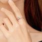 Hand wearing silver open mouse ring with curled tail design