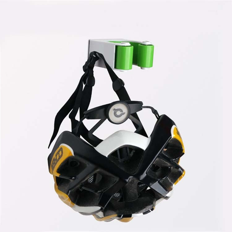 Bicycle helmet with black straps and green cylindrical top pieces