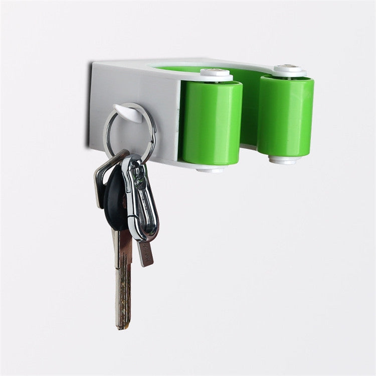 White wall mount with green cylinders and hanging keys on a metal ring