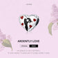 Small heart-shaped enamel charm with black silhouette and red heart accents on silver