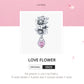 Silver flower charm bead with pink heart pendant, looped charm bale