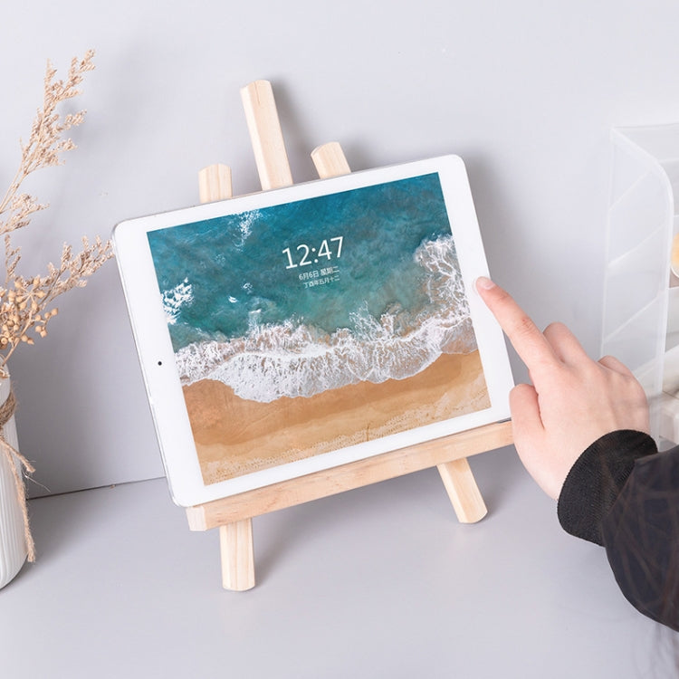 Folding wood easel stand with tablet display, hand adjusting the screen