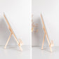 Two-angle view of folding wooden easel stand for tablets and phones