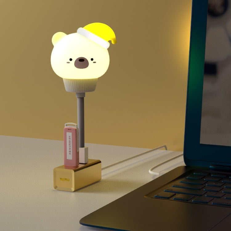 Cute bear LED night light with yellow cap and warm glow on a base