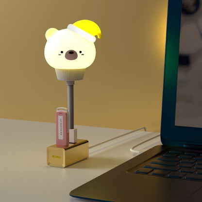 Cute bear LED night light with yellow cap and warm glow on a base