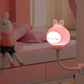 Cute pink rabbit LED night light with closed-eye face on a flexible stand